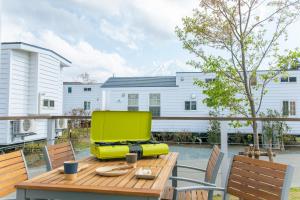 a patio with a wooden table and a yellow chair at インザ富士 in Fujiyoshida +40 photos
