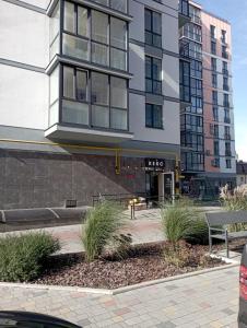 a building with tall windows and plants in front of it at ЖК Dream Town, Lutsk in Lutsk
