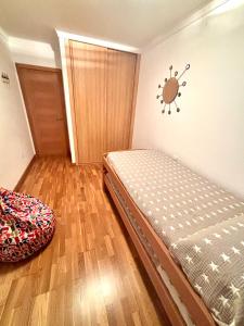 a bedroom with a bed and a wooden floor at Portosin Sea&Pool in Portosin +16 photos