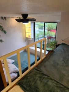 a room with a bunk bed and a window at Condo Stay near Philippine Arena - Chiara's Stay Inn in Marilao