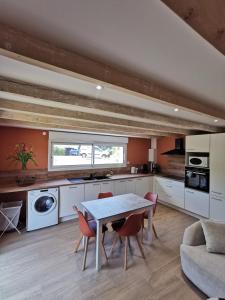 a kitchen with a table and chairs in a room at L'ancre jaune in Moyenmoutier