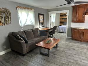 a living room with a couch and a table at Tropical Mountain Valley Casita in Mesa +81 photos