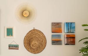a wall with pictures and a clock on a wall at Experience Elevated Living at this Pure South Penthouse in Manilva