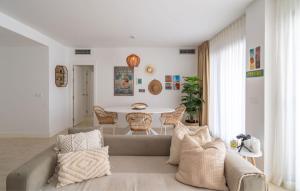 a living room with a couch and a table at Experience Elevated Living at this Pure South Penthouse in Manilva