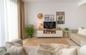 a living room with a tv and a couch at Experience Elevated Living at this Pure South Penthouse in Manilva +39 photos