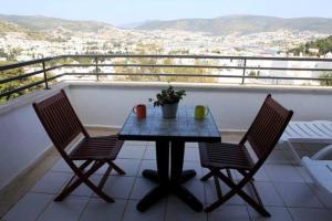 a table and two chairs on a balcony at Emelce Apart in Bodrum City