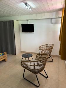 a waiting room with three chairs and a table at Le Pitaya in Sainte-Rose
