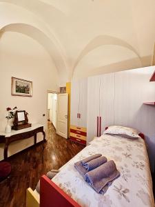 a bedroom with a bed with towels on it at Suite Santa Caterina in Altamura