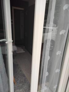 a sliding glass door with a view of a room at Tréornou in Brest +1 photo