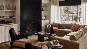 a living room with a couch and a fireplace at Mountainside by Windham Mountain Club in Windham
