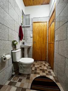 a bathroom with a toilet and a sink at Guazú Departamentos in Puerto Iguazú +12 photos