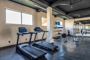a gym with treadmills and ellipticals in a room at Bakal Studios in Tulum