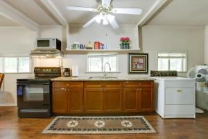 a kitchen with wooden cabinets and a ceiling fan at Bike and Hike On-Site Inviting Cleveland Retreat! in Cleveland +16 photos