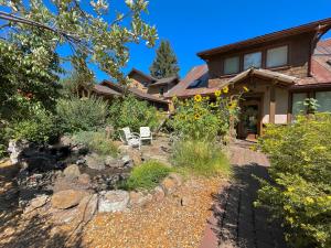 a house with a yard with a rock garden at The Davenport - Meredith Lodging in Bend
