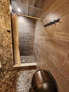 a bathroom with a shower with a toilet in it at Star-Lake Yurt Sanctuary Waterview in Red Bay +63 photos