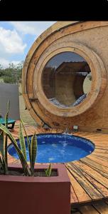 a circular pool on a wooden deck with a wooden at Glampings Magic Bungalow in Villa de Leyva +11 photos