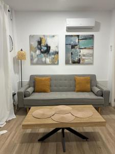 a living room with a couch and a coffee table at Nuestro lugar feliz Apartamento Barbate - Patio ducha exterior in Barbate