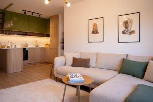 a living room with a couch and a table at Sapling Apartment in Prishtinë