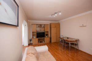 a living room with a couch and a table at IZZY Apartament in Făgăraş