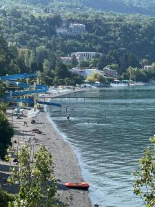 a beach with people swimming in the water at Apartment Joco in Ohrid