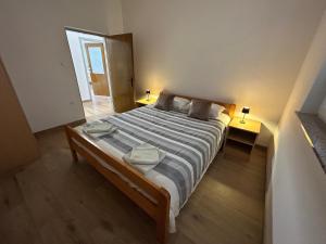 a bedroom with a large bed with two lamps at Apartman Caminito in Zadar