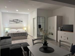a living room with a bed and a dining room table at Apartment Hortenzija in Baška Voda