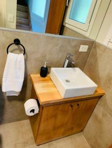 une salle de bains avec un lavabo blanc et un miroir dans l'établissement Complejo Pradera Centro, à San Martín de los Andes 17 autres photos