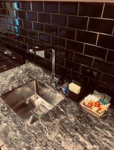 un comptoir de cuisine avec un évier et un panier de nourriture dans l'établissement Complejo Pradera Centro, à San Martín de los Andes