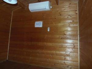 a room with a wooden wall with a air conditioner at Eleven Auto Camp Park - Vacation STAY 44746v in Kururi