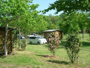 a white van parked in a yard with a house at Eleven Auto Camp Park - Vacation STAY 44748v in Kururi