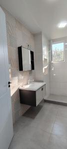 a bathroom with a sink and a mirror on the wall at Villa Harmony Tianeti in Tʼianetʼi +6 photos