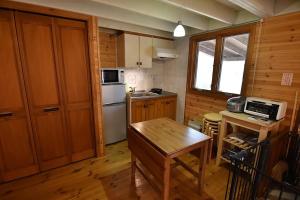 a kitchen with wooden cabinets and a table in a room at Eleven Auto Camp Park - Vacation STAY 44750v in Kururi