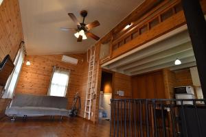 a living room with a bed and a ceiling fan at Eleven Auto Camp Park - Vacation STAY 44750v in Kururi