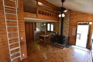 a living room with a ladder and a kitchen at Eleven Auto Camp Park - Vacation STAY 44750v in Kururi