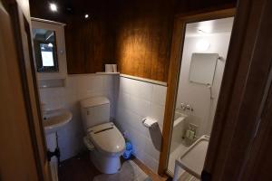 a small bathroom with a toilet and a sink at Eleven Auto Camp Park - Vacation STAY 44750v in Kururi