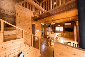 a log home with a staircase and a dining room at Eleven Auto Camp Park - Vacation STAY 44751v in Kururi