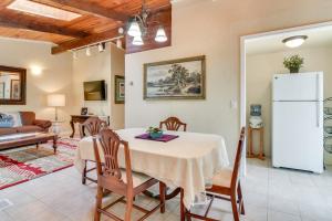 a kitchen and living room with a table and chairs at 12 Mi to Portland Aloha Home with Private Backyard in Aloha