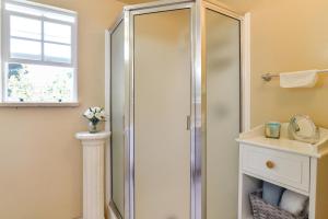 a shower with a glass door in a bathroom at 12 Mi to Portland Aloha Home with Private Backyard in Aloha +18 photos