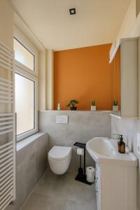 a bathroom with a toilet and a sink at Casa Mateo Mediterranes Studio in Bielefeld