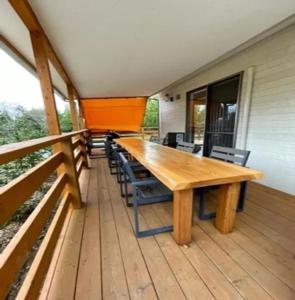 a wooden table and chairs on a deck at Eleven Auto Camp Park - Vacation STAY 44752v in Kururi