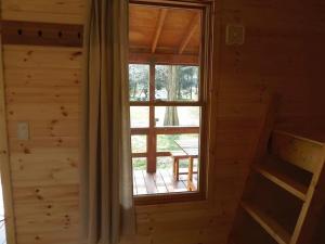 a room with a window in a log cabin at Eleven Auto Camp Park - Vacation STAY 44749v in Kururi