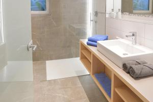 a bathroom with a sink and a shower at Landhaus Hirsch in Obermaiselstein +35 photos