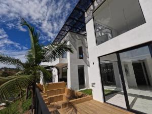 a house with a palm tree in front of it at Finca Las palmas Guatape in Guatapé +25 photos