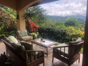 a patio with a table and chairs and a view at Luxury In The Jungle in Barú