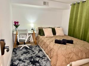 a bedroom with a bed and a desk and a table at Hotel-Style, No Host, Professionally Managed ID247 in Jersey City