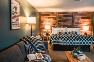 a hotel room with a bed and a couch at The Outpost by Windham Mountain Club in Windham