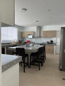 a large kitchen with a table and chairs in it at Acogedora casa de playa para la familia y amigos in San Antonio