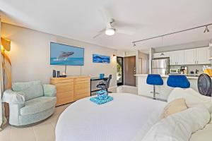a living room with a bed and a couch and a kitchen at Napili Ridge - Vacation West Maui in Lahaina +40 photos