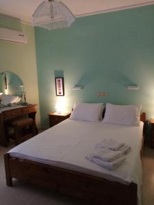 a bedroom with a bed with two towels on it at Lena Blue Sea Apartments in Kalami +61 photos