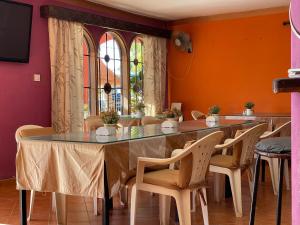 a dining room with a table and chairs at Auberges des Cocotiers du Sine Saloum in Fatick